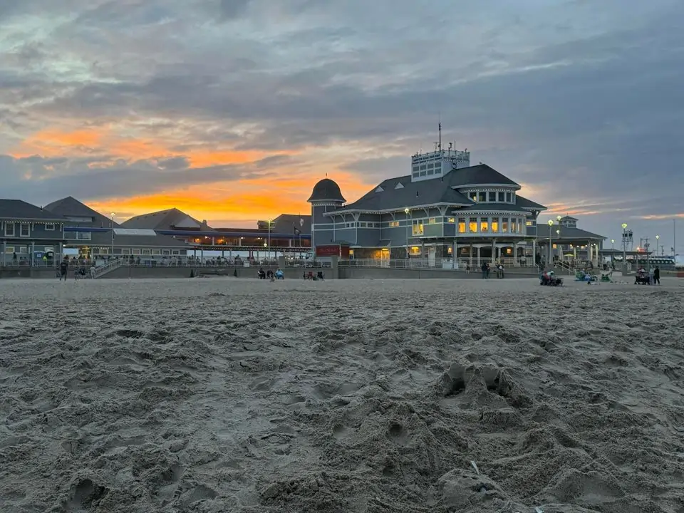 picture of hampton beach sand facing in towards seashell stage and casino ballroom close to sunset